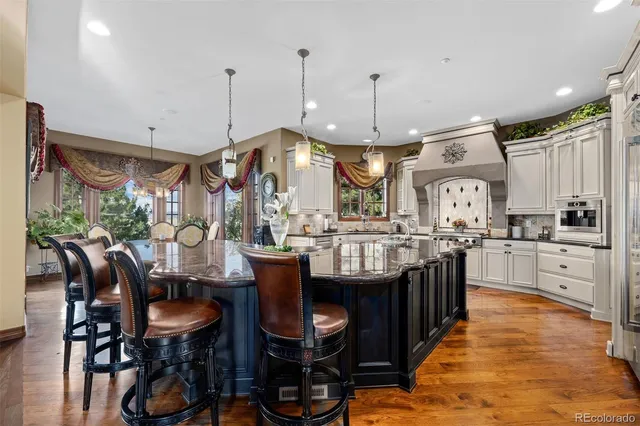 a large kitchen with lots of counter space and furniture