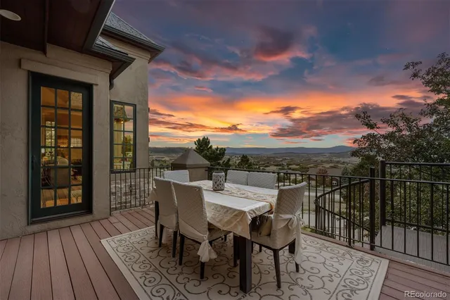 a view of a roof deck with furniture
