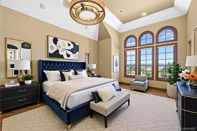 a spacious bedroom with a bed a couch and a large window