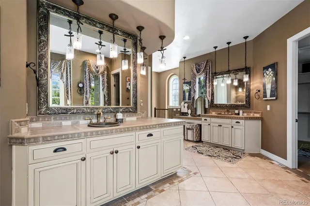 a bathroom with a granite countertop sink mirror and shower