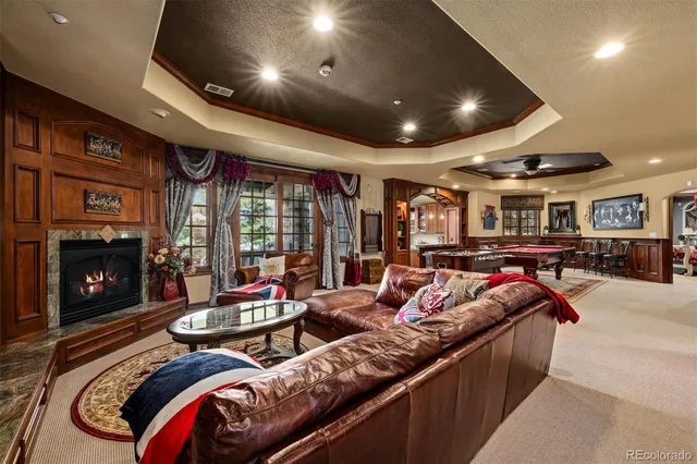 a living room with furniture a fireplace and a projector