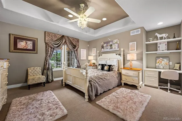 a bedroom with a bed couch and window