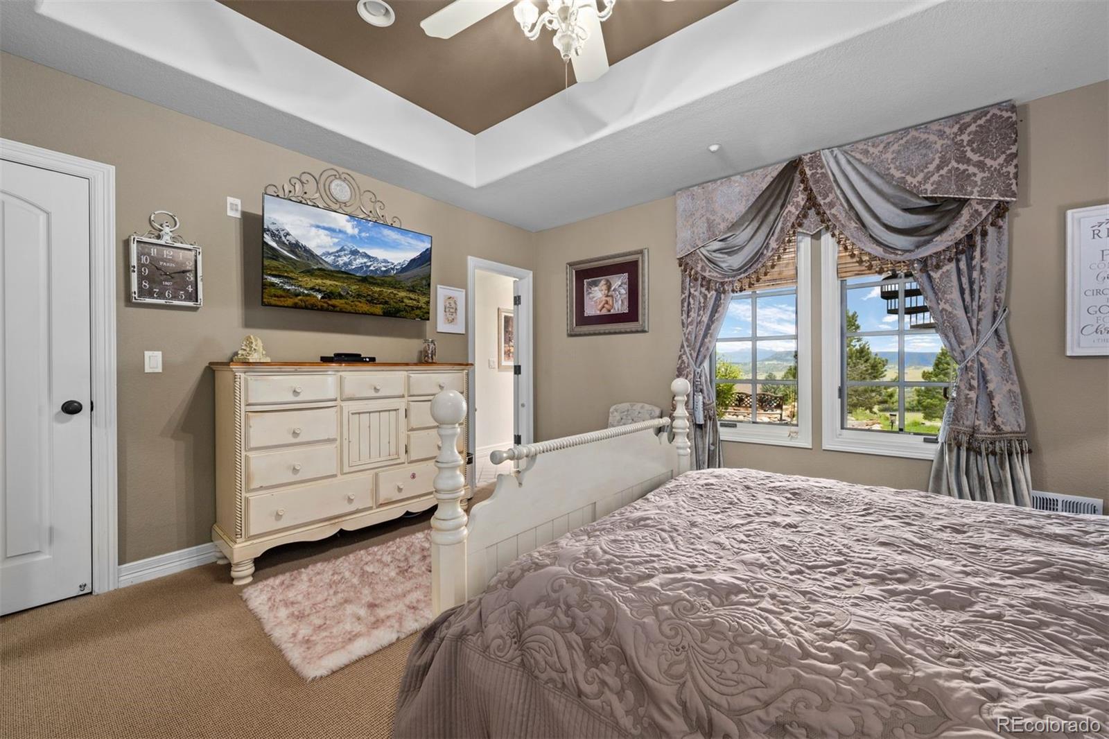 3440 Medallion Road Castle Rock, CO 80104 - Photo 43 of 50 a bedroom with a bed and a flat screen tv