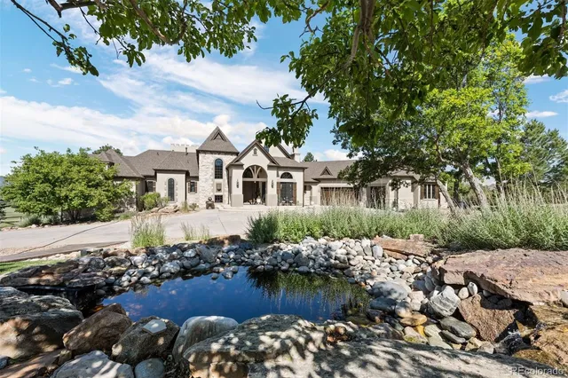 a view of a house with a yard and sitting area