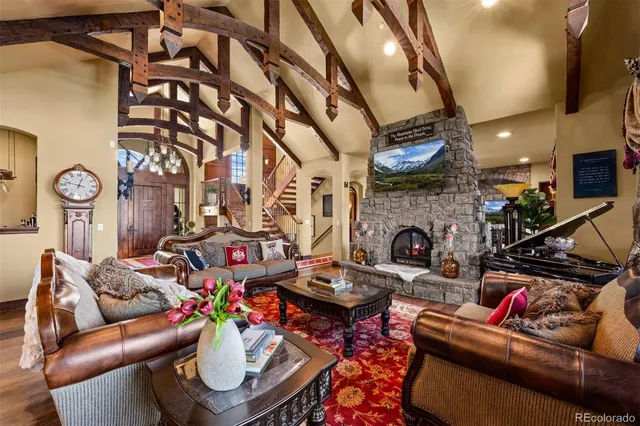 a living room with furniture a fireplace and a chandelier