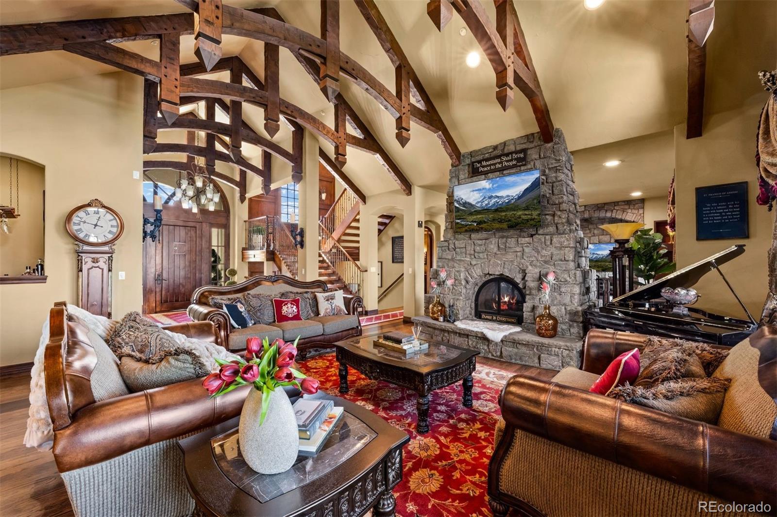 3440 Medallion Road Castle Rock, CO 80104 - Photo 10 of 50 a living room with furniture a fireplace and a chandelier