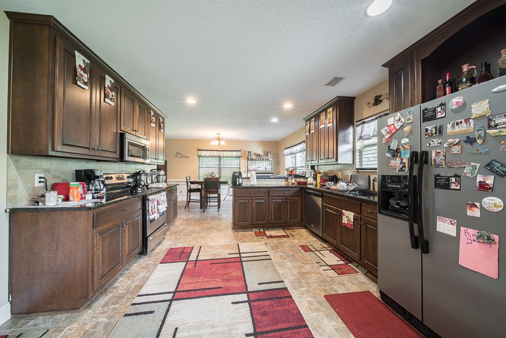 18 Summershade Court Fort Mitchell, AL 36856 - Photo 12 of 37 a kitchen with stainless steel appliances granite countertop a refrigerator and a stove