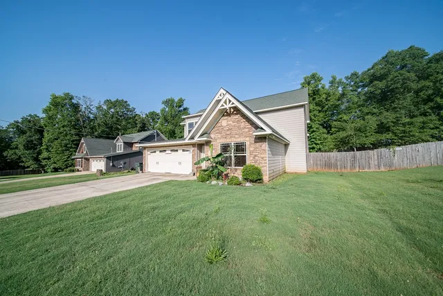 a view of a house with a yard and deck