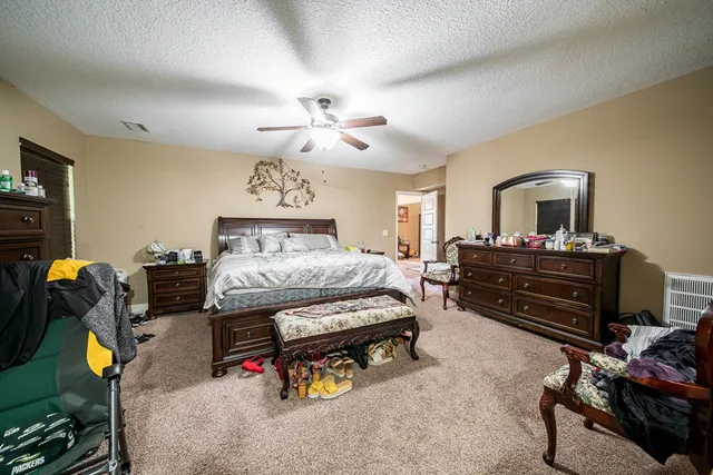 a bedroom with furniture and a mirror