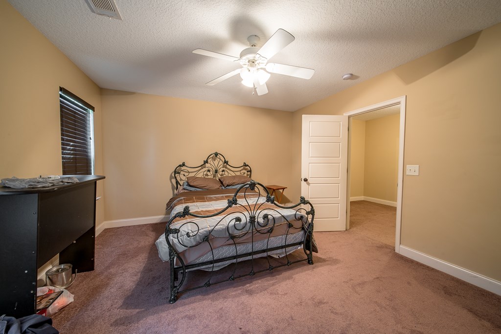 18 Summershade Court Fort Mitchell, AL 36856 - Photo 26 of 37 a bedroom with a bed and a chandelier