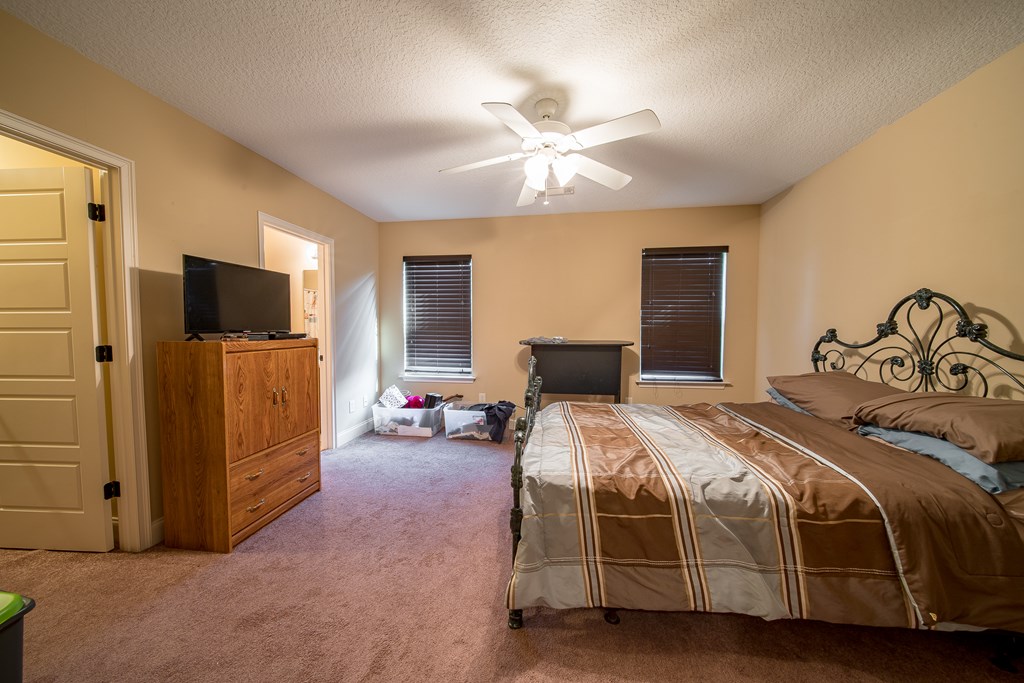 18 Summershade Court Fort Mitchell, AL 36856 - Photo 27 of 37 a bedroom with a bed and a flat screen tv