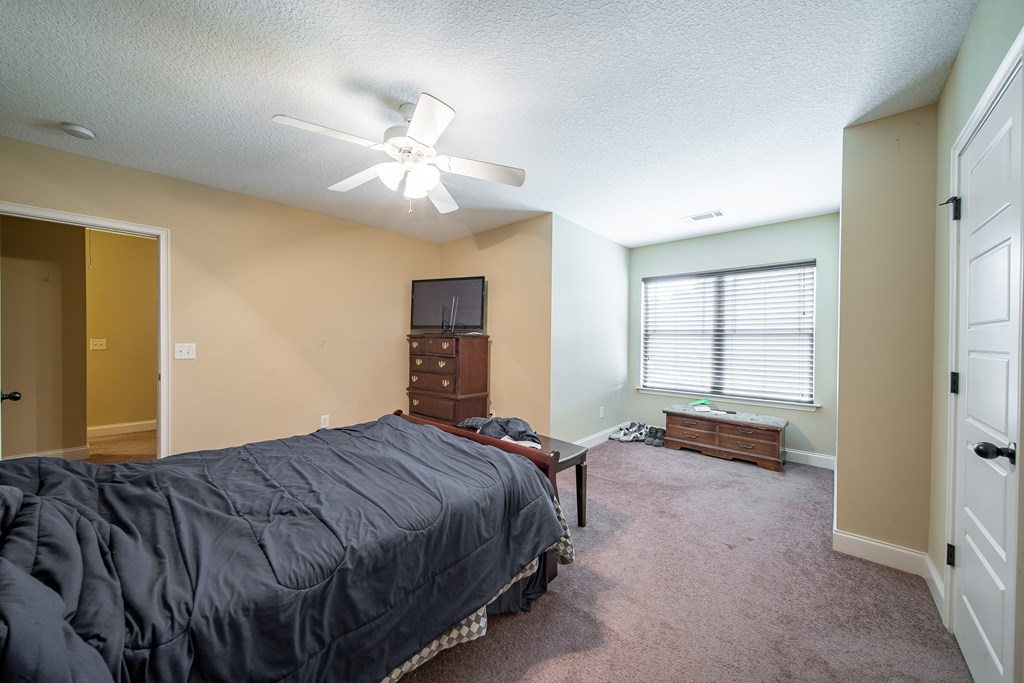 18 Summershade Court Fort Mitchell, AL 36856 - Photo 36 of 37 a bedroom with a bed and dresser with mirror