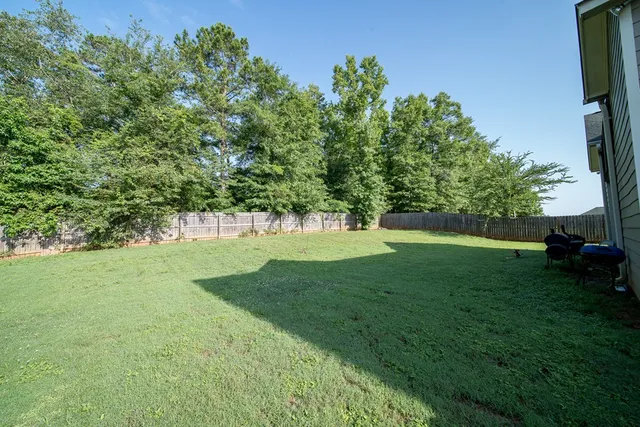 a view of yard with grass and a trees