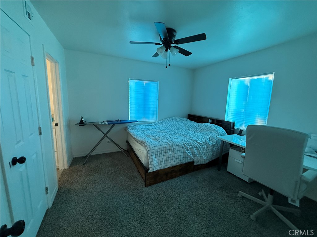 290 North 3rd Street Blythe, CA 92225 - Photo 4 of 6 a bedroom with a bed and a chandelier