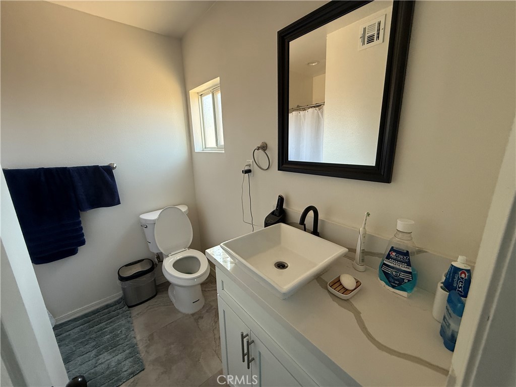 290 North 3rd Street Blythe, CA 92225 - Photo 6 of 6 a bathroom with a sink toilet and mirror