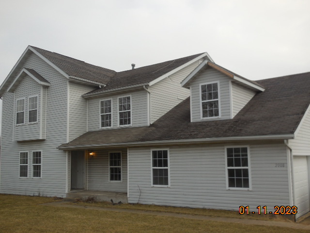 2008 Ridge Creek Drive Bloomington, IL 61705 - Photo 1 of 14 a front view of a house with garage