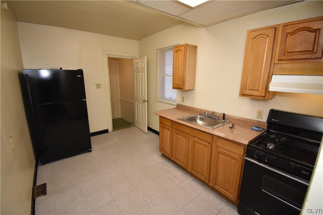 43 South Warren Street Easton, PA 18042 - Photo 5 of 13 a kitchen with stainless steel appliances a refrigerator and a stove