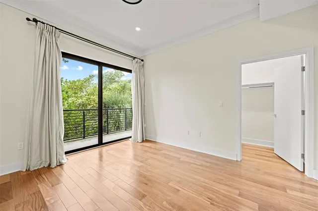a view of an empty room and wooden floor
