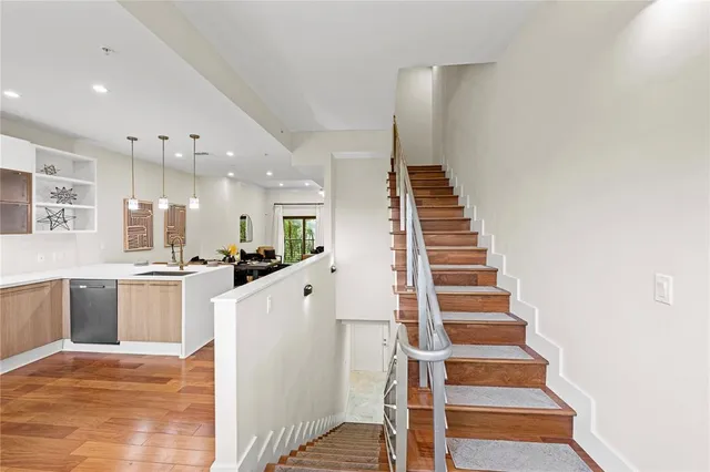 a view of kitchen with sink and refrigerator