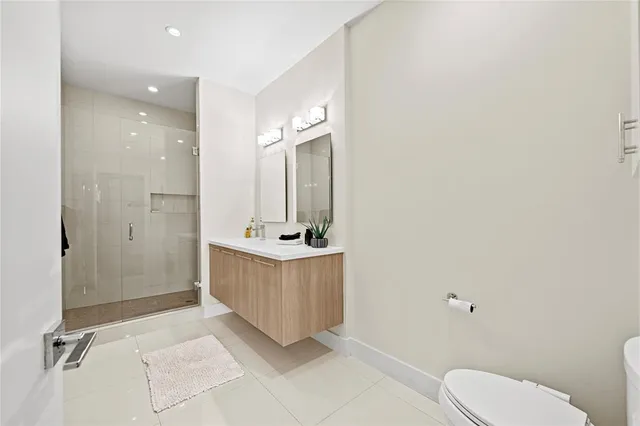 a bathroom with a sink a large mirror and shower