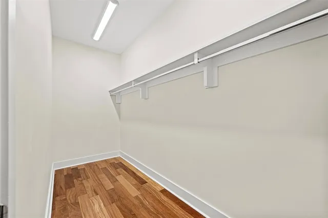 a view of hallway with wooden floor