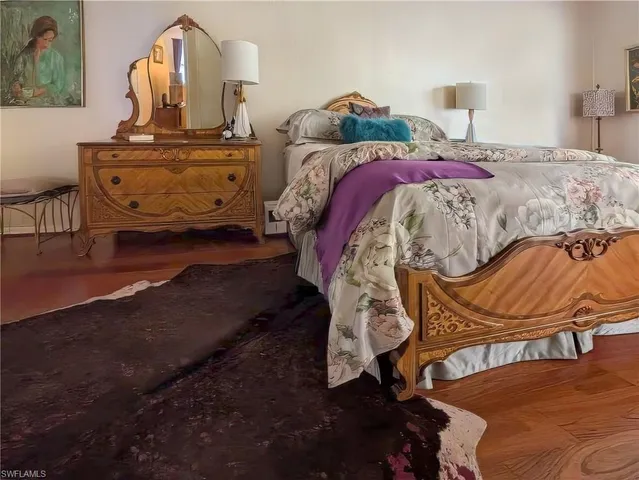 a bedroom with a bed and dresser