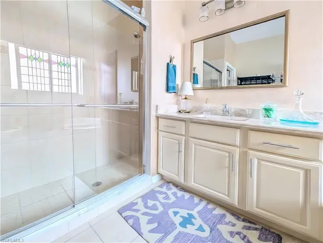 a bathroom with a sink a mirror and a shower
