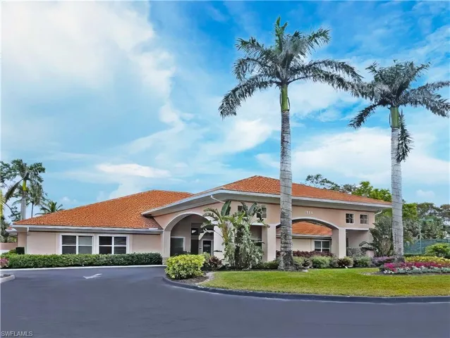 a living room with furniture windows and a chandelier