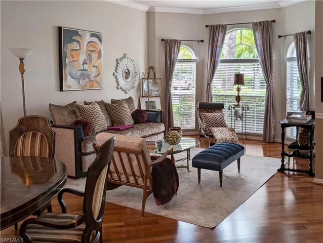 a living room with furniture fireplace and a large window