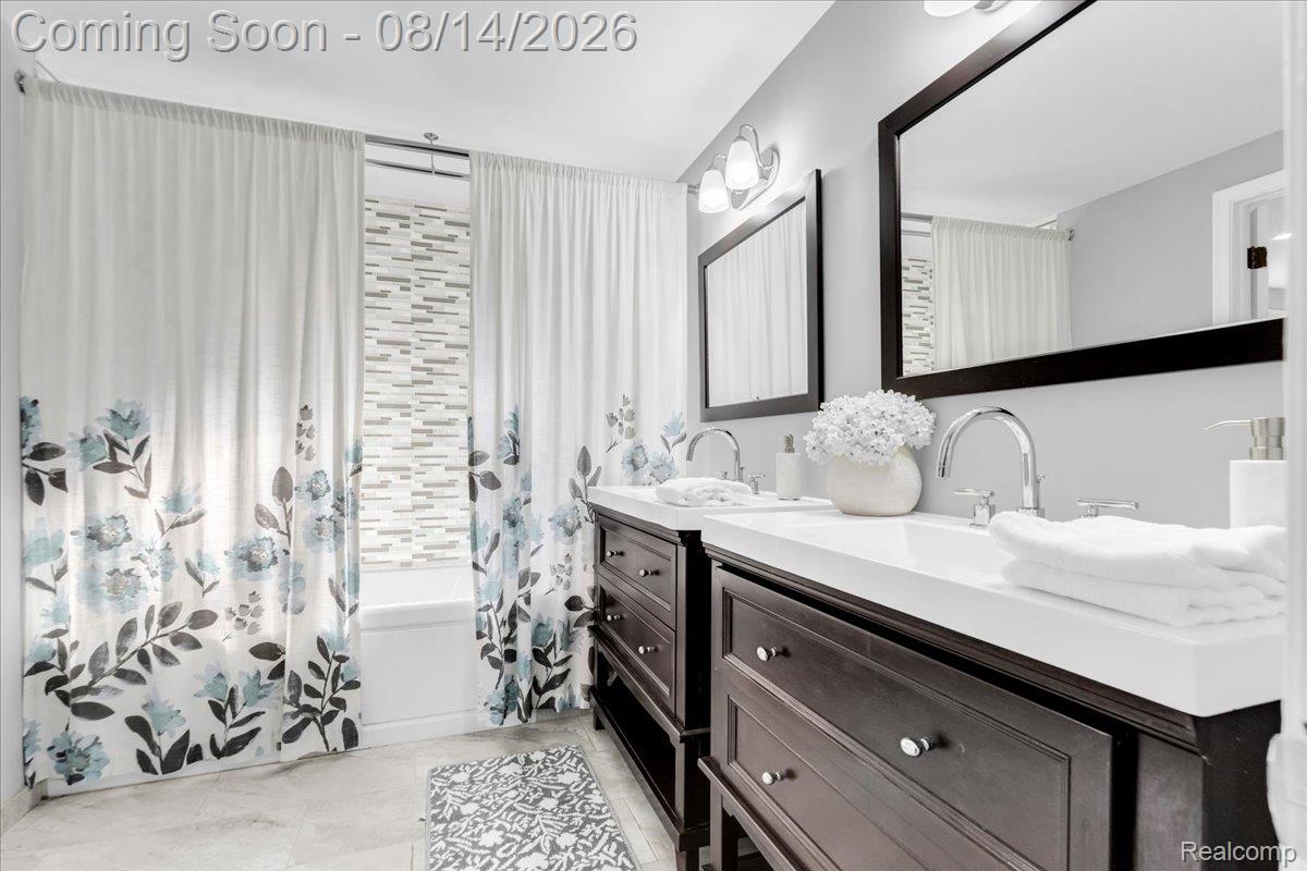 47321 Susan Road Macomb, MI 48044 - Photo 24 of 46 Dual vanity with white countertops, chrome fixtures, and dark wood-finish cabinetry
