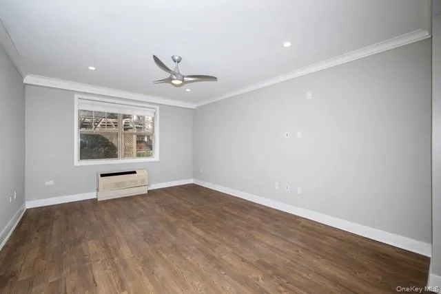 wooden floor in an empty room with a window