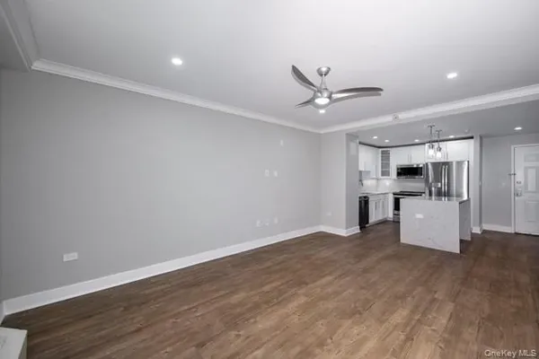 a view of kitchen with wooden floor and a ceiling fan