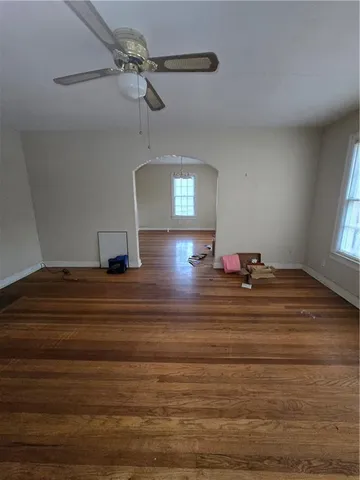 a view of a room with a mirror and ceiling fan