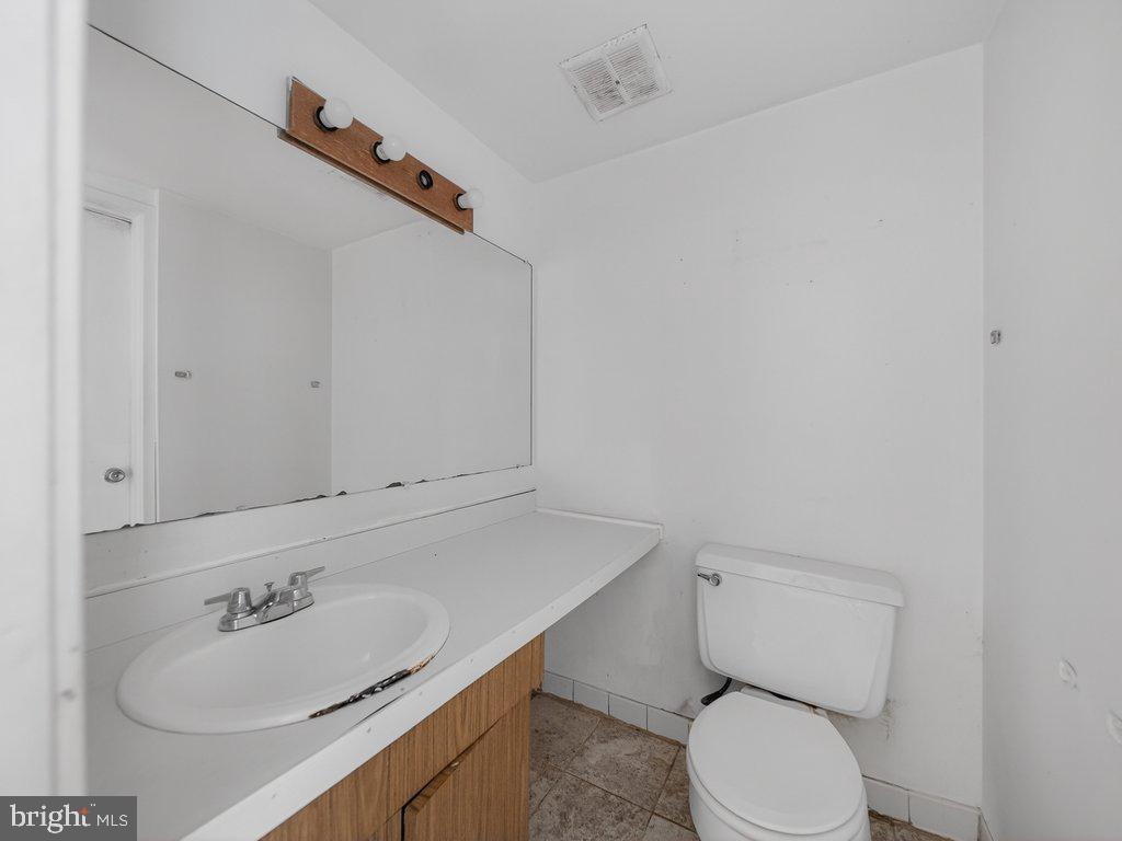 9635 White Acre Road, Unit B2 Columbia, MD 21045 - Photo 17 of 31 a white toilet sitting next to a bathroom sink