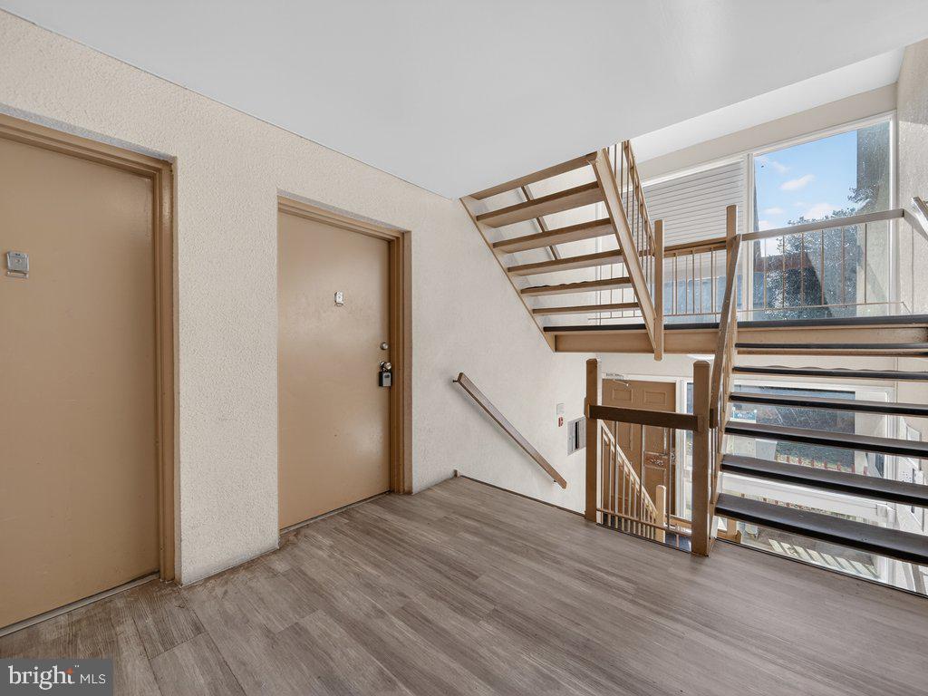 9635 White Acre Road, Unit B2 Columbia, MD 21045 - Photo 5 of 31 a view of entryway with wooden floor and stairs