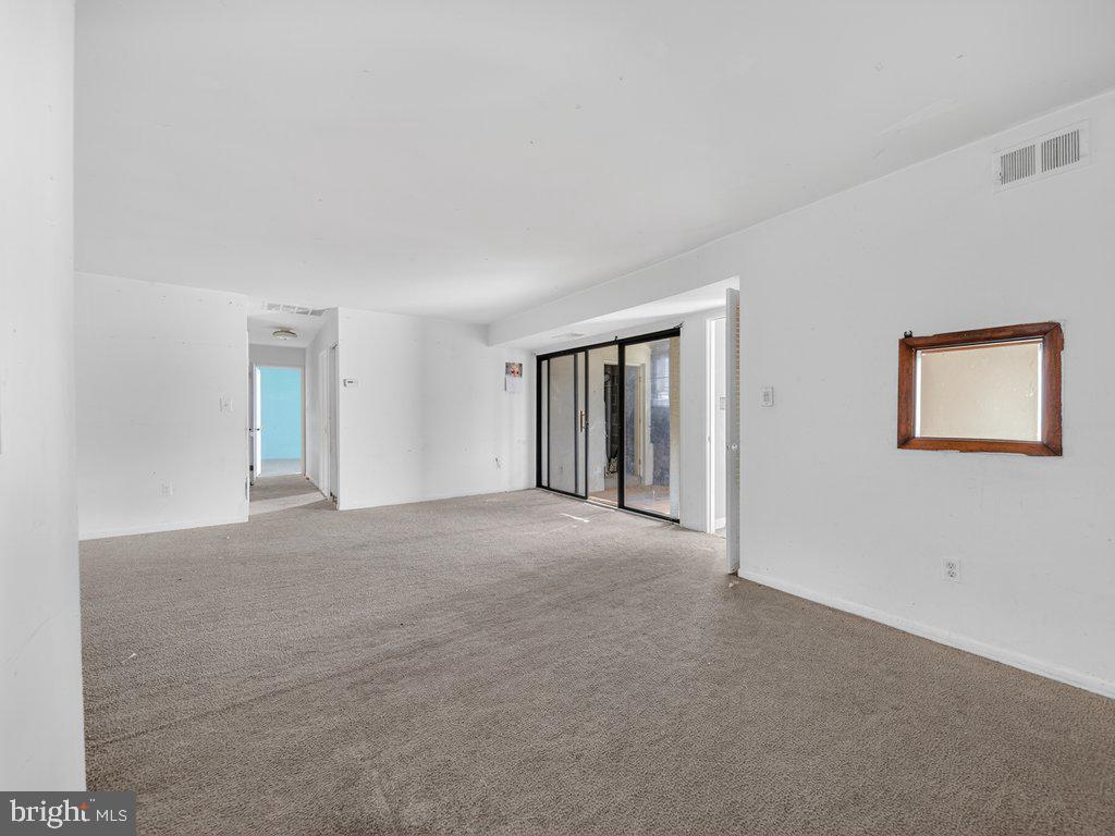 9635 White Acre Road, Unit B2 Columbia, MD 21045 - Photo 9 of 31 a view of an empty room with window and wooden floor