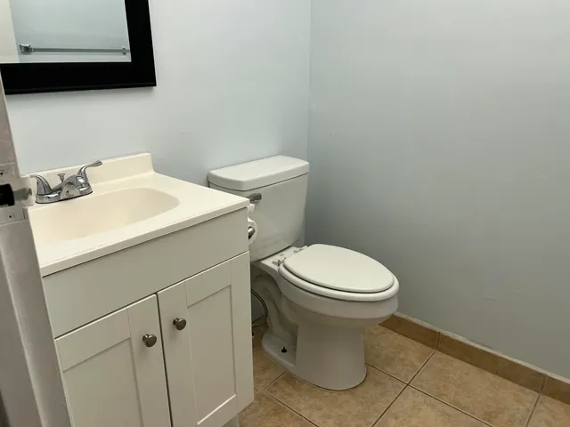 a white toilet sitting next to a bathroom sink