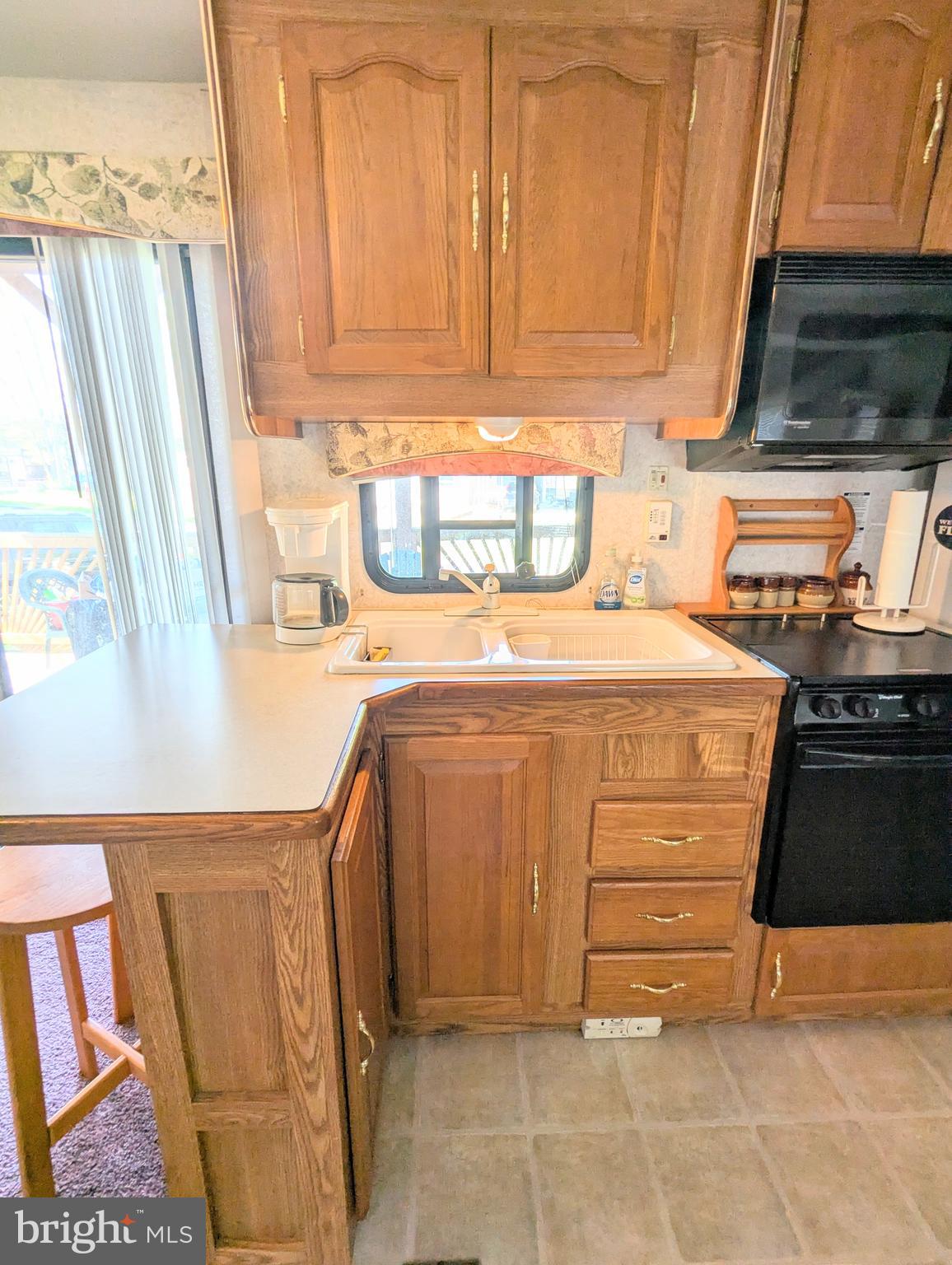 8 Avalanche Avenue Falling Waters, WV 25419 - Photo 4 of 13 a kitchen with granite countertop a sink and a stove
