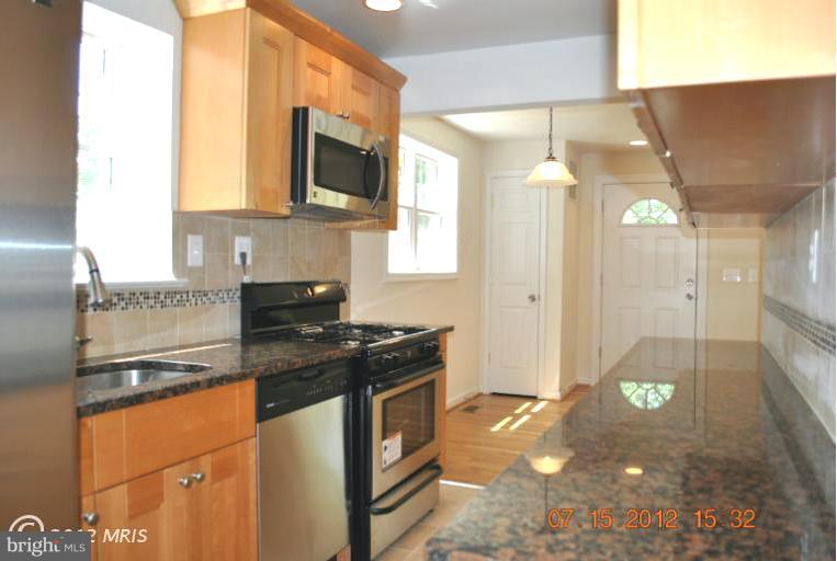 2904 Harris Avenue Silver Spring, MD 20902 - Photo 4 of 17 a kitchen with stainless steel appliances granite countertop a sink stove and refrigerator