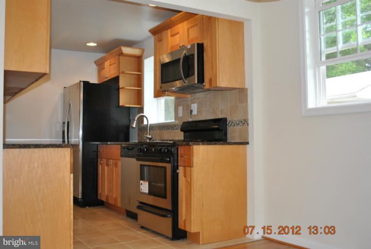 2904 Harris Avenue Silver Spring, MD 20902 - Photo 5 of 17 a kitchen with stainless steel appliances granite countertop a refrigerator and a stove