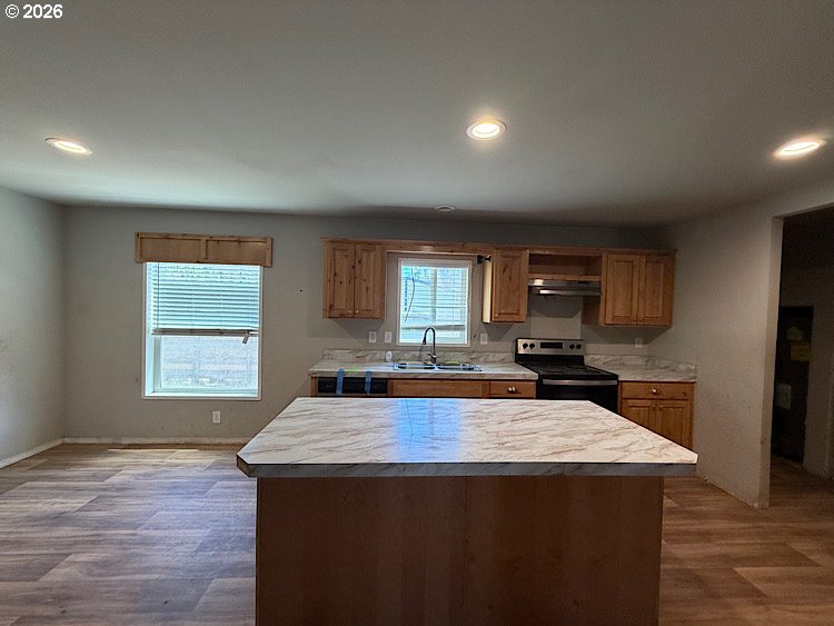 16125 Hawks Lair Road La Pine, OR 97739 - Photo 14 of 35 a kitchen with kitchen island a sink stove and refrigerator