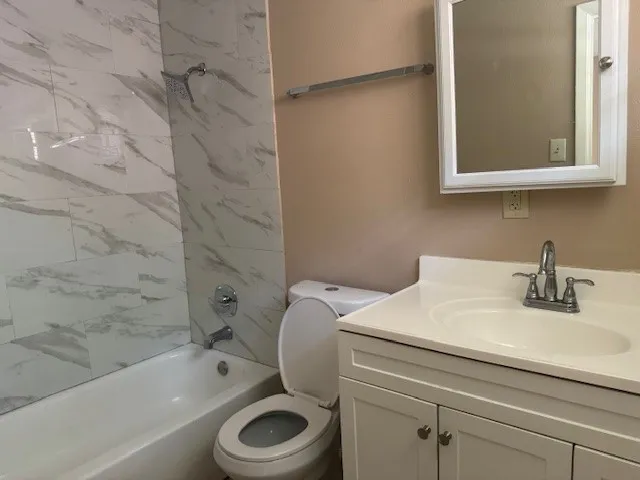 a bathroom with a sink a toilet and bathtub