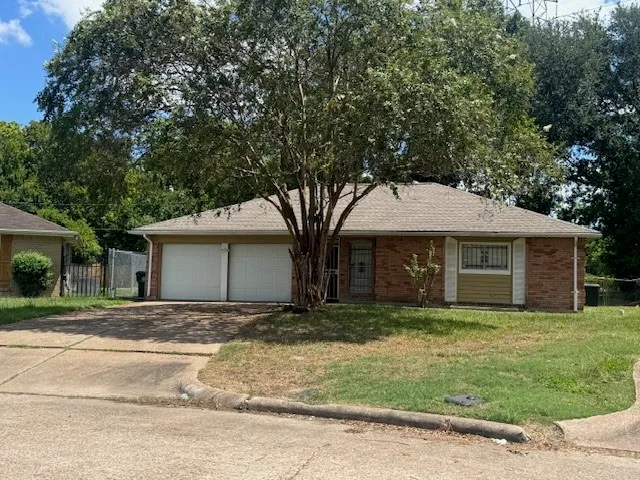 a front view of house with yard and trees