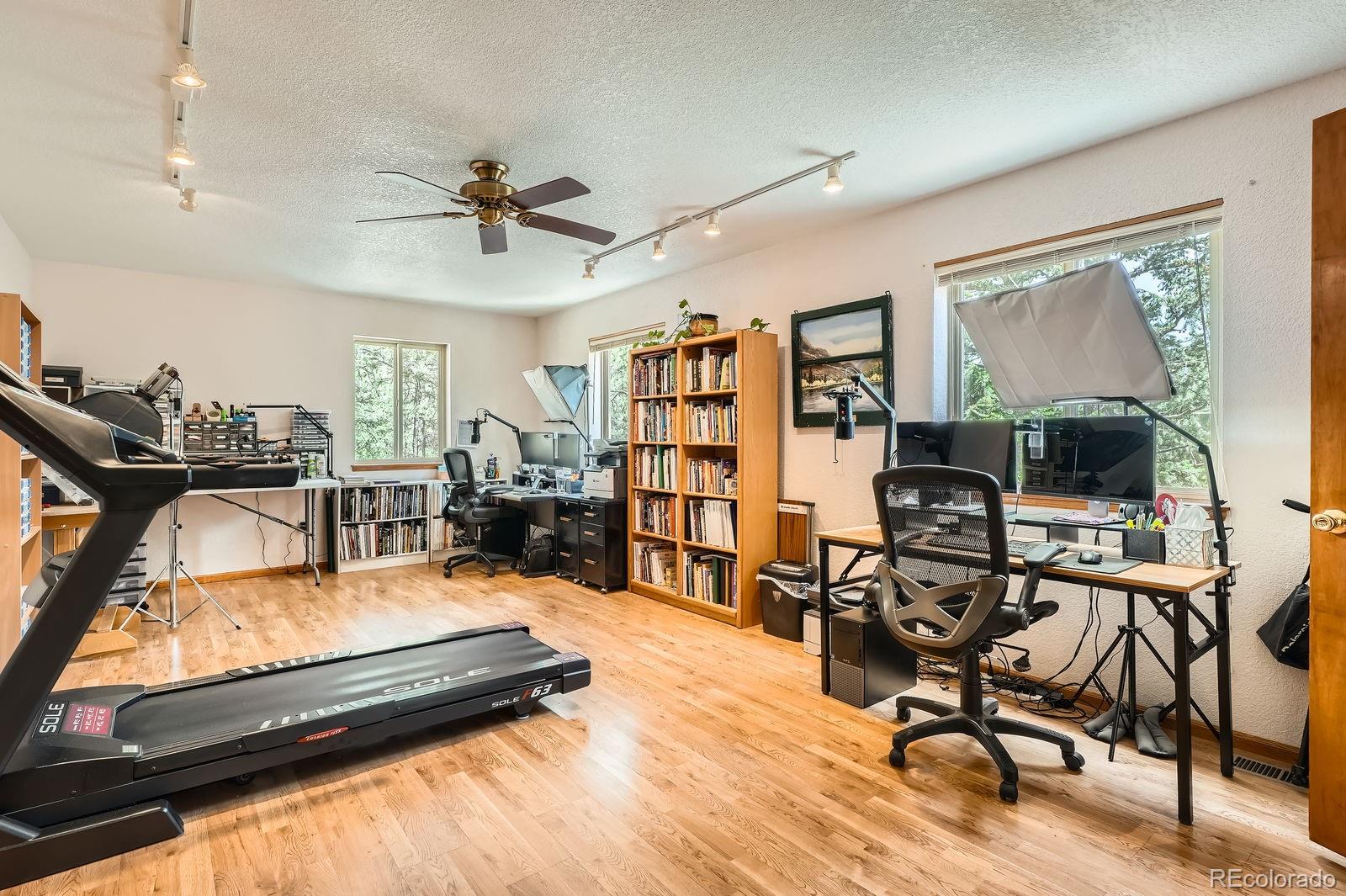 84 Marys Lane Bailey, CO 80421 - Photo 22 of 35 a living room with furniture gym equipment and a flat screen tv