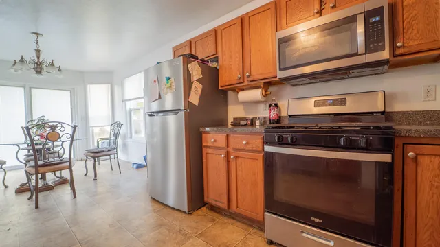 a kitchen with stainless steel appliances granite countertop a stove and a refrigerator