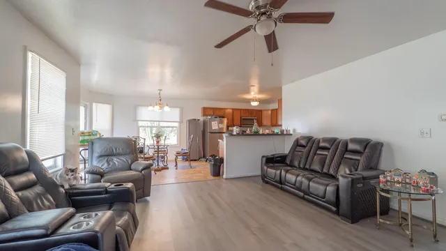 a living room with furniture and a wooden floor