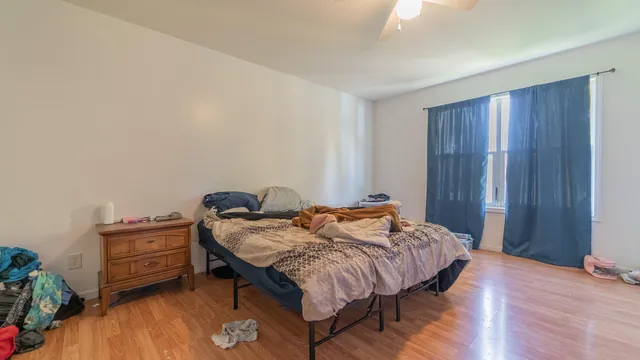 a bedroom with a bed and a dresser