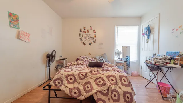 a bedroom with a large bed and a window