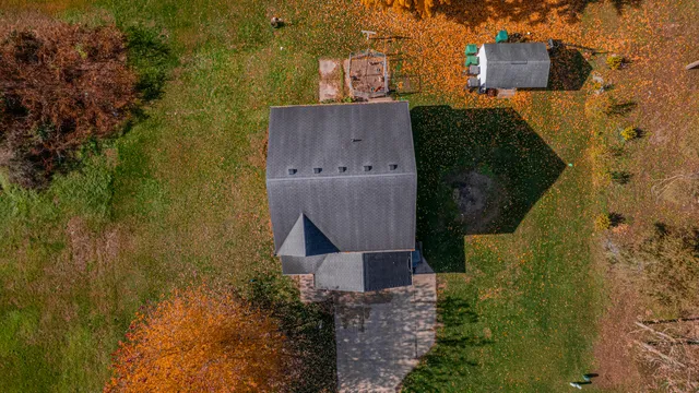 an aerial view of a house with a yard
