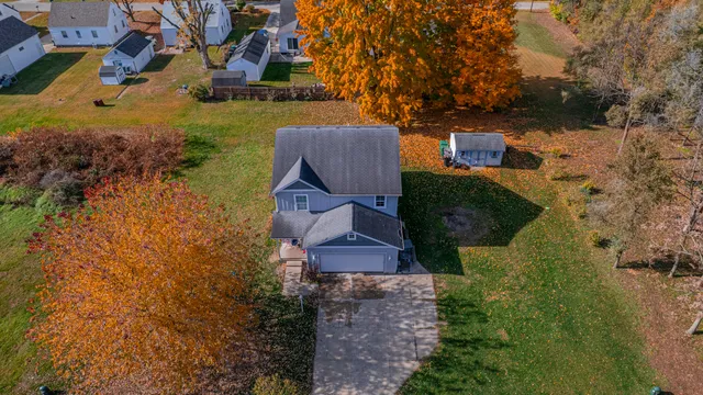 an aerial view of a house with garden space and street view